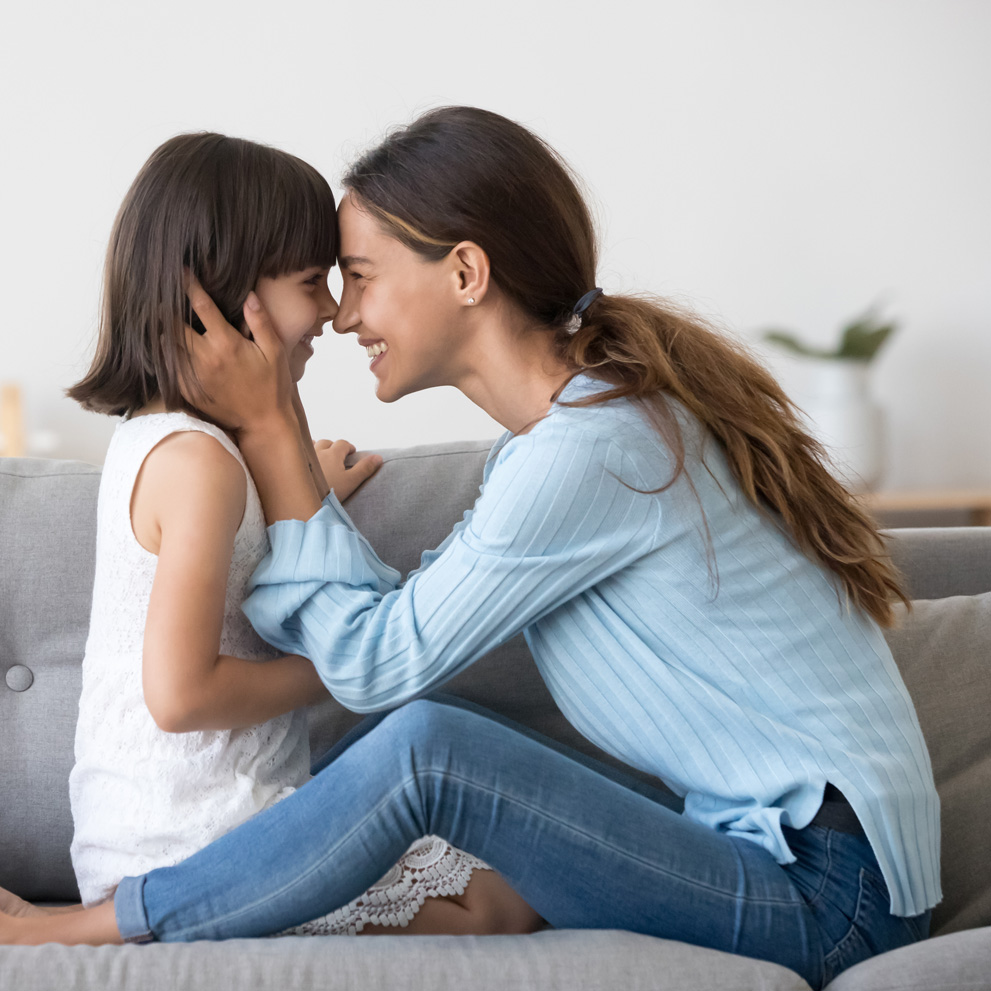 Photo of a young mother touching noses with her child