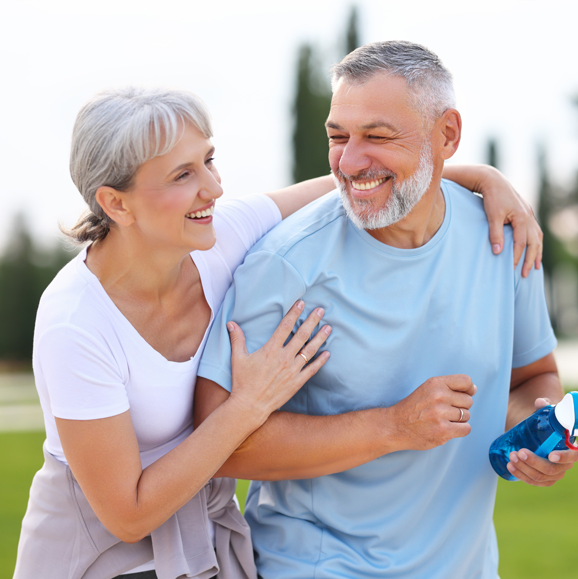 Photo of a healthy older couple exercising in the park