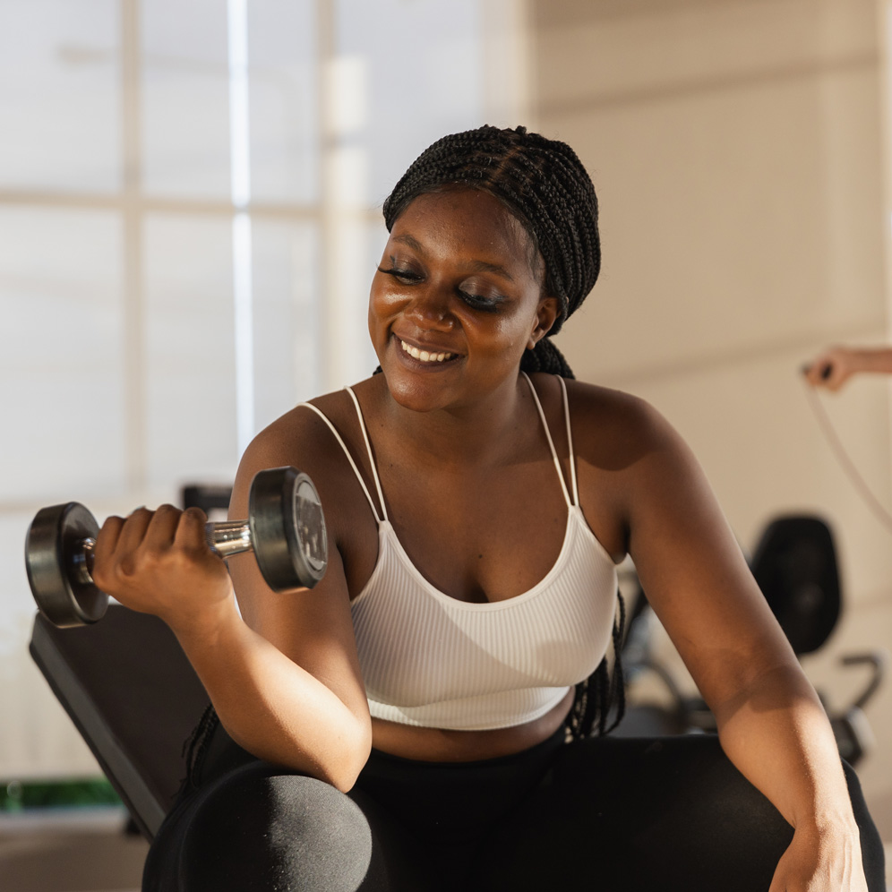 Photo of a young, strong woman weight training